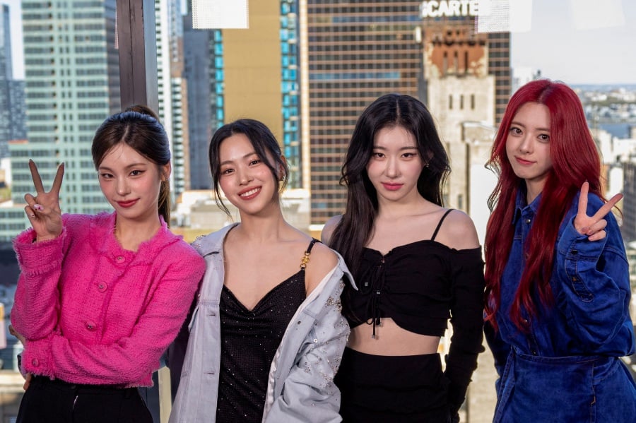 Members of the group Itzy pose in front of the Manhattan skyline during an interview with Reuters in New York, U.S. (REUTERS/Andrew Kelly)