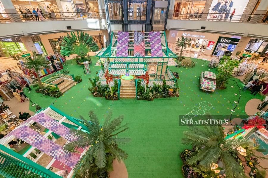 The Suria KLCC Centre Court has been transformed into a lush Malaysian garden adorned with cascading bougainvilleas, majestic palm trees, and local tropical foliage. 