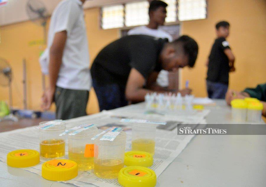 A file pic shows students undergoing urine test conducted by the National Anti-Drugs Agency (Nada), at a school. - NSTP file pic