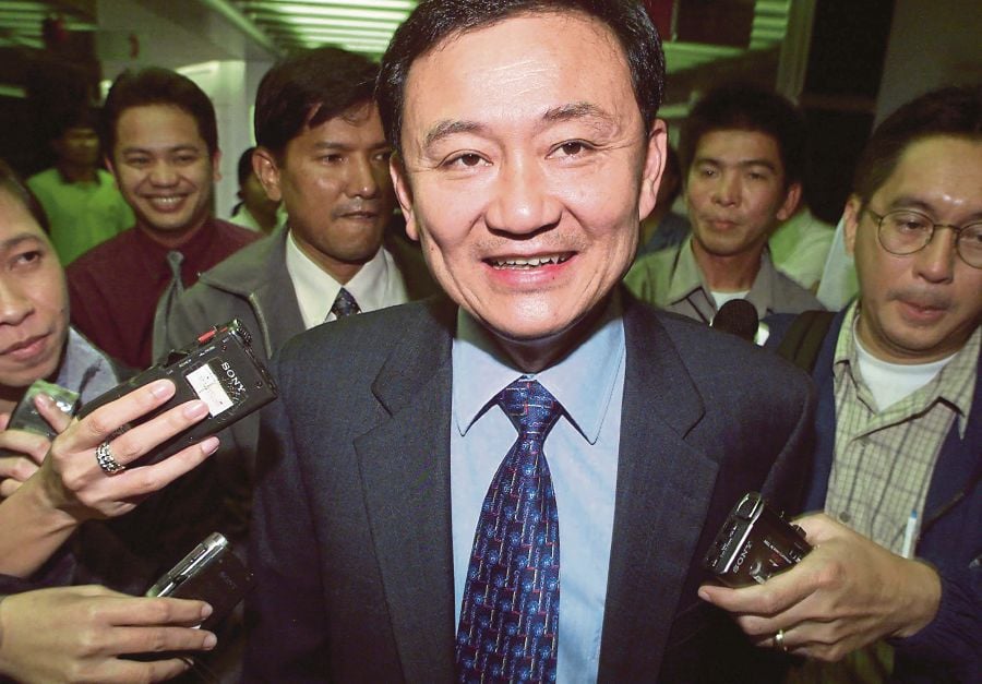 Former Thai prime minister Thaksin Shinawatra talking to the media in 2001. He left a police hospital after six months on Sunday and returned to his home. AFP PIC 