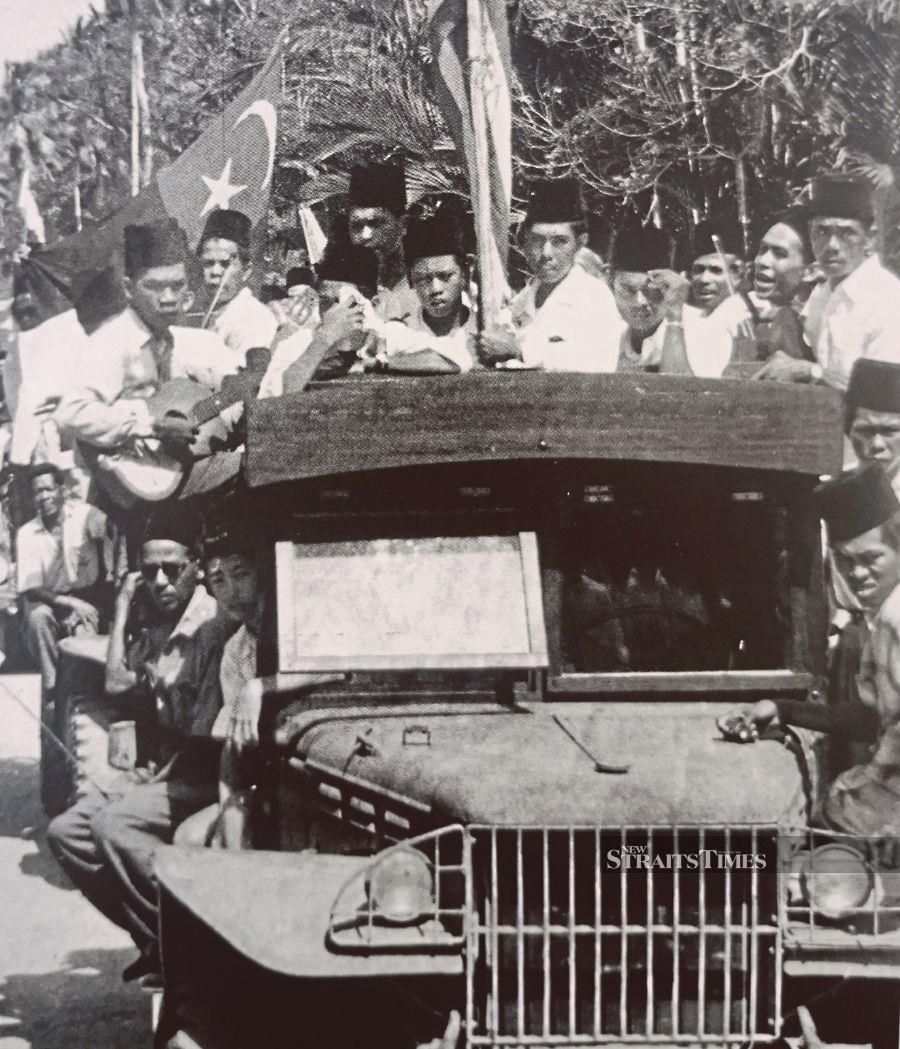 A Johor flag flying on a lorry carrying Segamat musicians to a function in the early 1950s. - Pic by Alan Teh Leam Seng 