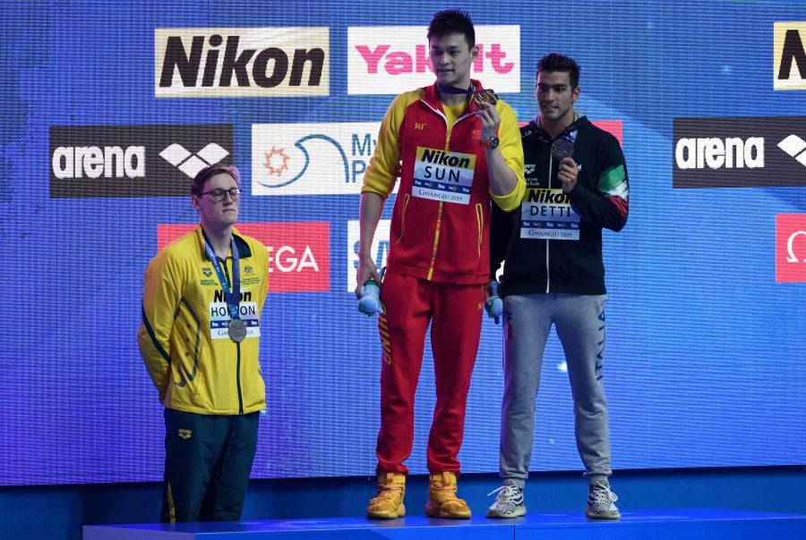 Silver medallist Australia's Mack Horton (L) refuses to stand on the podium with gold medallist China's Sun Yang (C) and bronze medallist Italy's Gabriele Detti after the final of the men's 400m freestyle event during the swimming competition at the 2019 World Championships at Nambu University Municipal Aquatics Center in Gwangju, South Korea, on July 21, 2019. AFP FILE PIC
