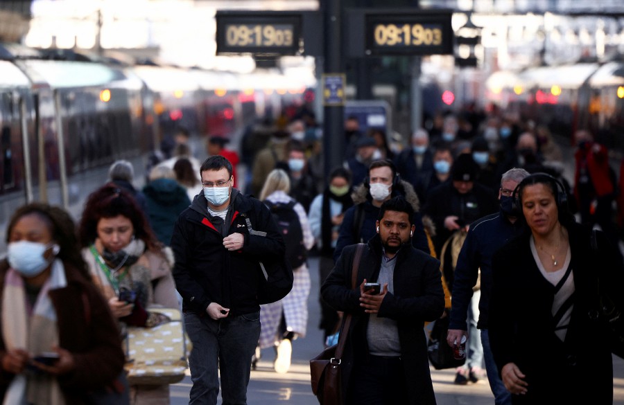 People walk along a platform at King's Cross train station, amid the ongoing coronavirus disease (COVID-19) outbreak in London, Britain, January 21, 2022. -REUTERS PIC