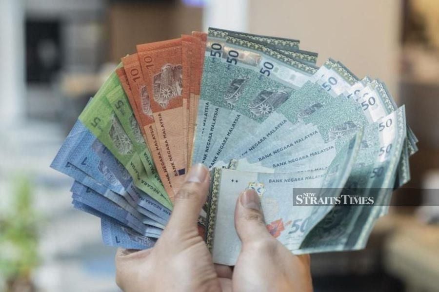 The ringgit opened lower against the US dollar this morning, weighed down by robust US labour market data, said an analyst.