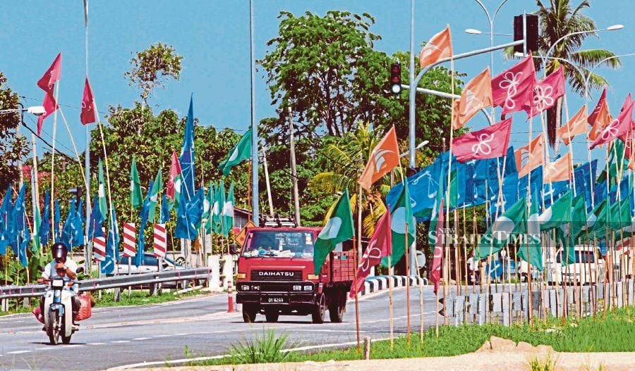 Flags of political parties lining a road in Tumpat, Kelantan, for the 14th General Election in 2018. - NSTP file pic 