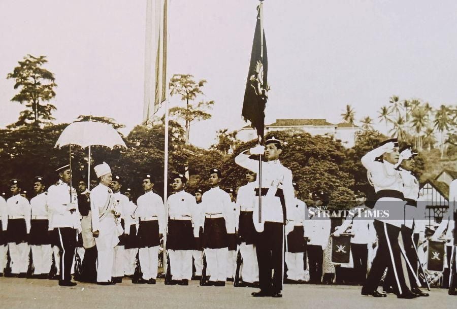 The then Yang di-Pertuan Agong Sultan Hisamuddin Alam Shah inspecting the Royal Malay Regiment guard of honour at the end of the Emergency Victory Parade in Kuala Lumpur on Aug 1, 1960. - Pix by Alan Teh Leam Seng