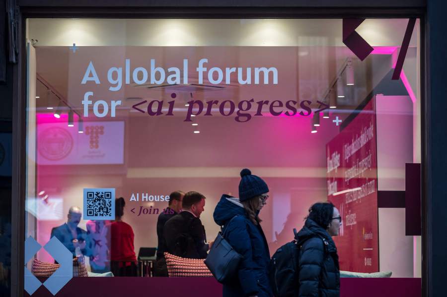 Women walk past a booth dedicated to the Artificial Intelligence (AI) during the World Economic Forum (WEF) annual meeting in Davos on January 18, 2024. AFP PIC