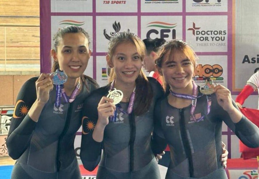 (From left) Malaysia's Anis Amira Rosidi, Nurul Aliana Syafika Azizan and Nurul Izzah Izzati Mohd Asri winning the Asian Cycling Championships elite team sprint silver at the Indira Gandhi Velodrome in New Delhi yesterday.