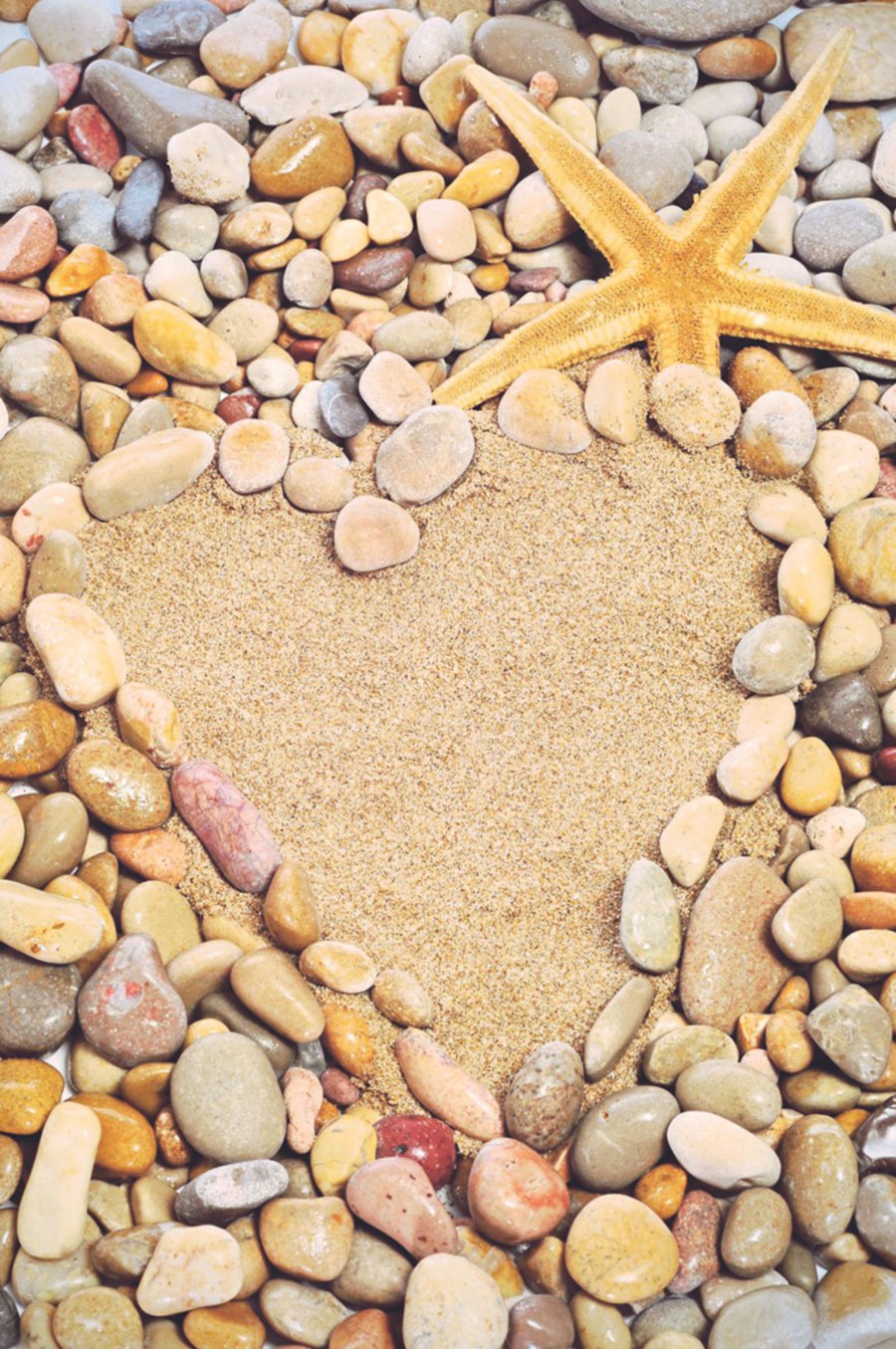 A pile of pebbles forming a heart with a sandy centre may be the perfect welcome to your rock garden.