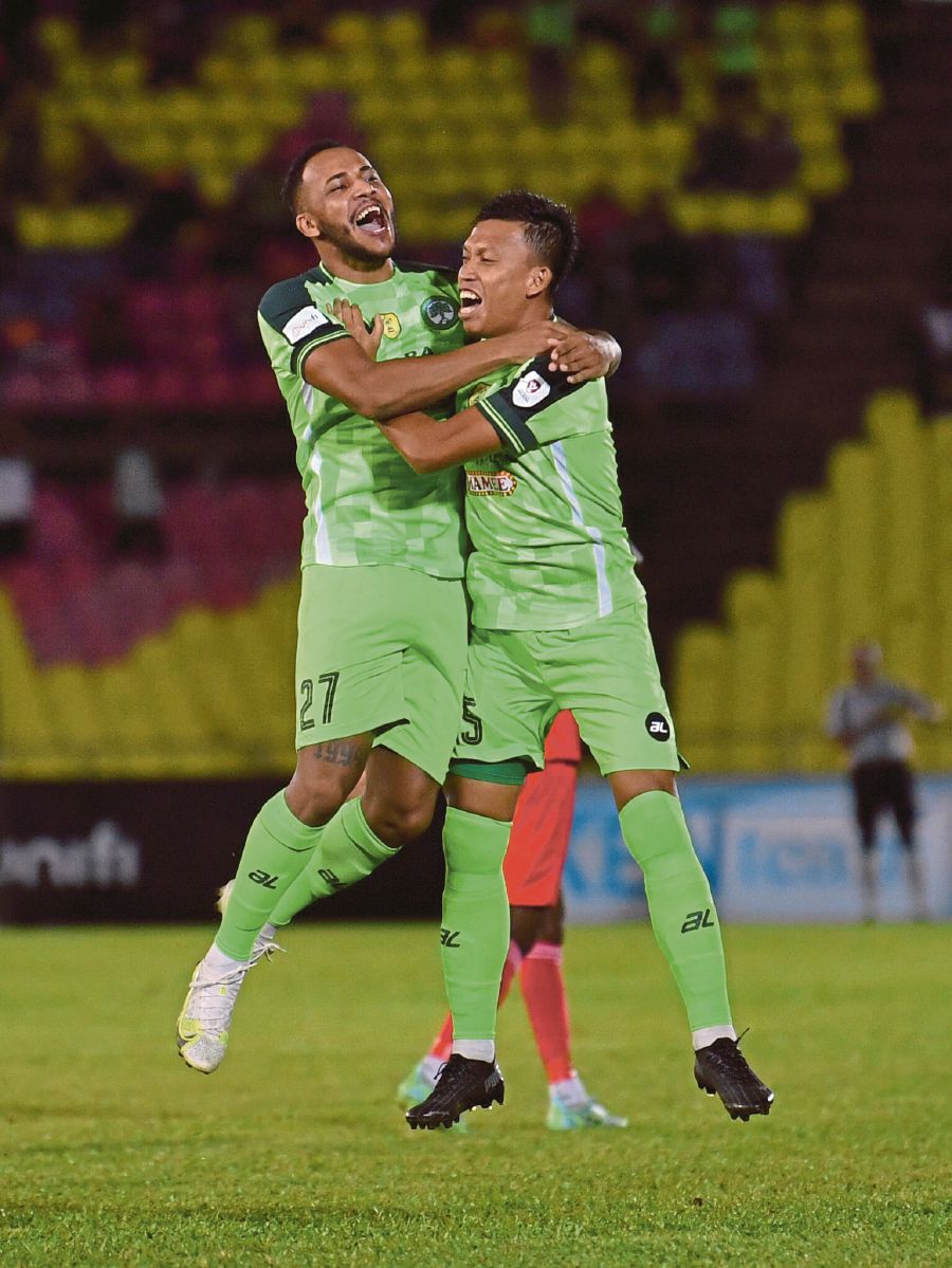  Melaka United’s Adriano Aparecido (left) is hugged by a teammate after scoring against Sabah in their second-leg quarter-final Malaysia Cup match on Thursday. - BERNAMA PIC 