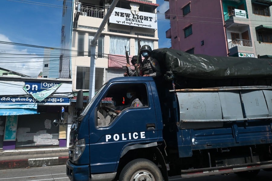 Police patrol in a truck in downtown Yangon on October 22, 2021. -AFP PIC