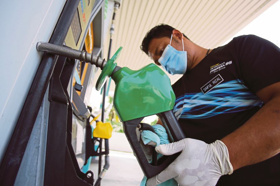 RON97 petrol will be paying six sen less per litre, starting tomorrow (March 28). --File pic via BERNAMA 