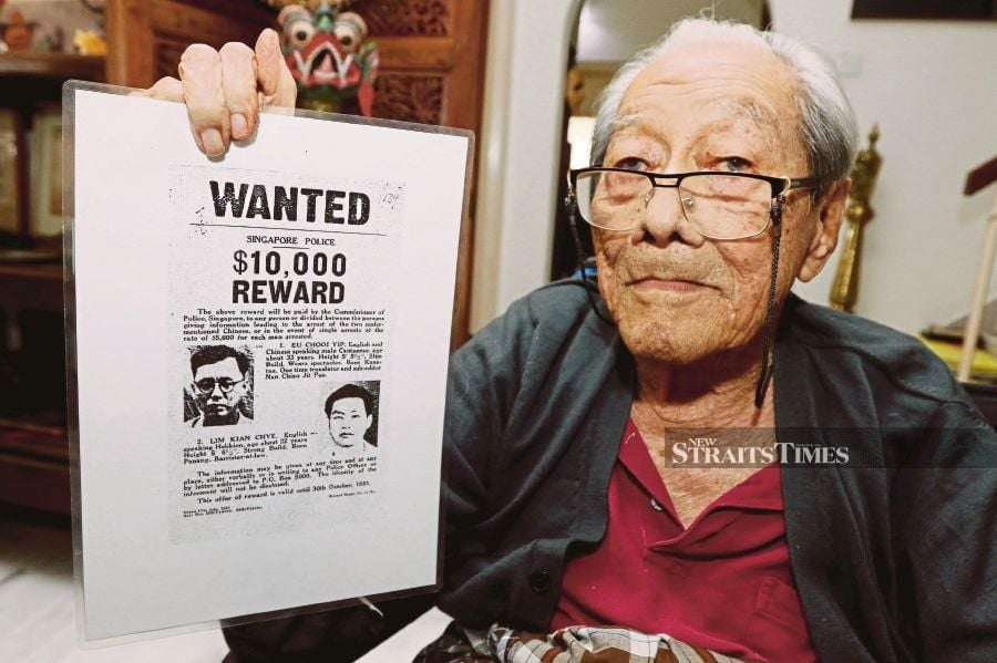 Malayan Democratic Union founder Lim Kean Chye showing a poster on the reward for his capture for being part of the anti-British league. -NSTP/Mikail Ong
