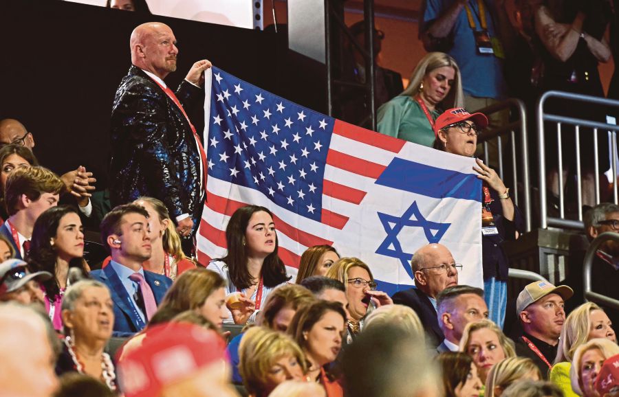 Attendees holding a flag made from the American and Israeli  flags during the 2024 Republican National Convention recently. Israeli settlers are working to convince Donald Trump and the Republican Party to drop longstanding US support for a Palestinian state. AFP PIC