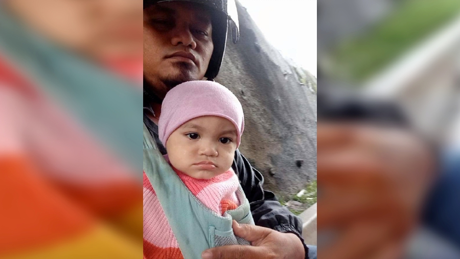 The image shows a screen capture of a video of Apai and his daughter, Nur Arisya, seeking cover beneath a bridge, which went viral on social media. -PIC COURTESY OF APAI