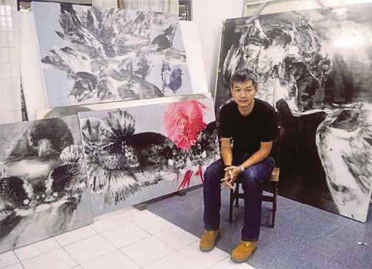 Lee with some of his paintings.