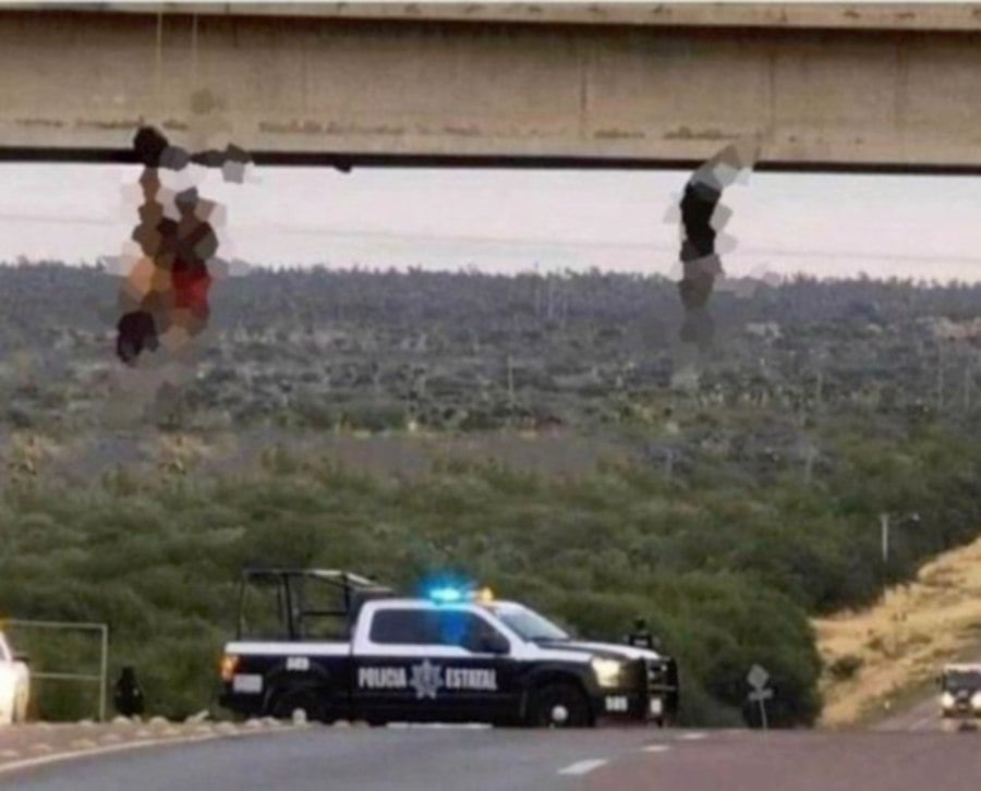 The file pic shows the bodies of two police officer found hanging from bridge in Zacatecas. 