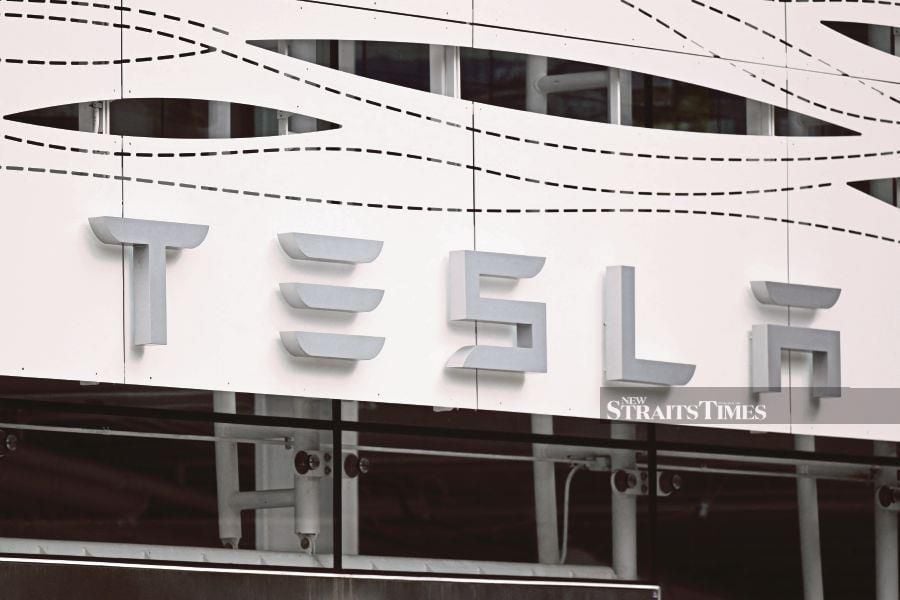 (FILES) The Tesla logo is seen in the picture. (Photo by Patrick T. Fallon / AFP)
