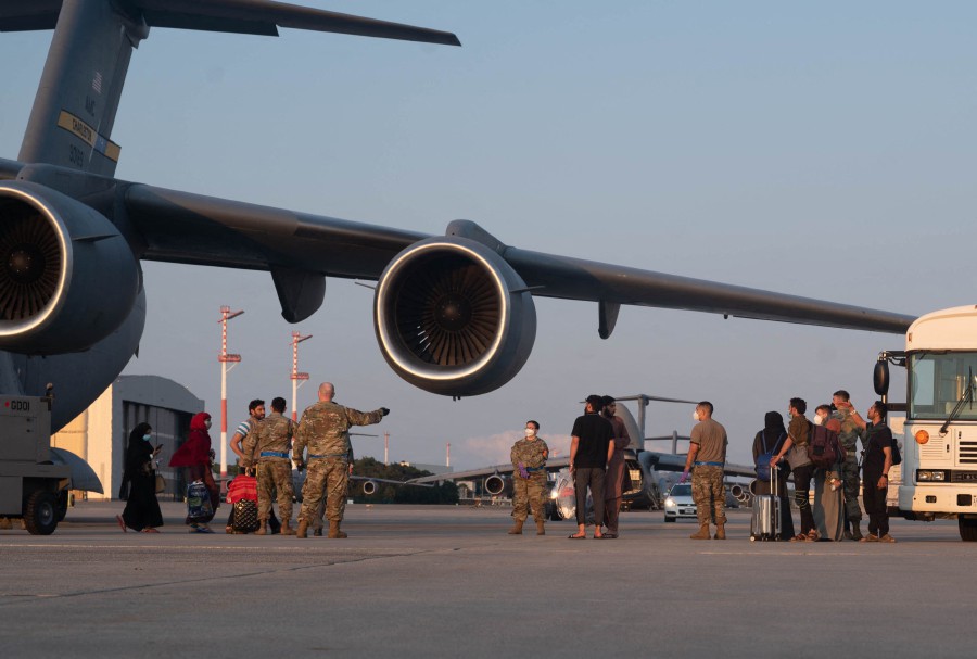 A group of Afghan evacuees depart a C-17 Globemaster III aircraft at Ramstein Air Base, Germany, on August 20, 2021.-AFP pic
