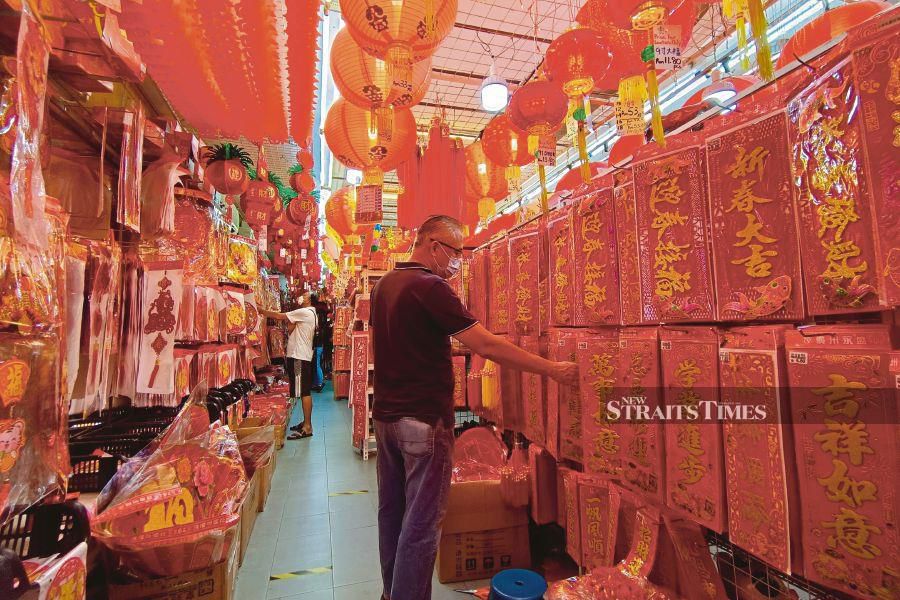 A man looking for items to buy for the upcoming Chinese New Year celebration in Melaka on Thursday. -NSTP/SYAFEEQ AHMAD