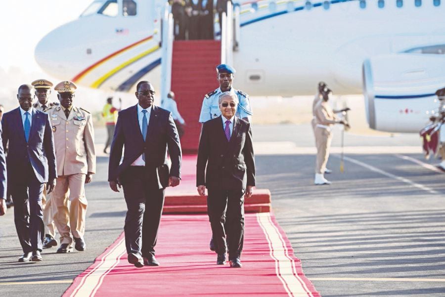 (File pix) Senegal President Macky Sall receiving Prime Minister Tun Dr Mahathir Mohamad at Leopold Sedar Senghor Airport in Dakar on Jan 16. To Senegal, Dr Mahathir is a living legend. Bernama Photo