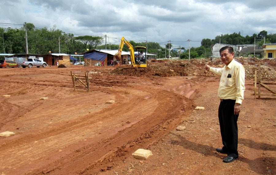 Sadao City Council mayor Sumet Sasithorn shows the 2.4 hectare land that will be used as the open air car park. Bernama pic