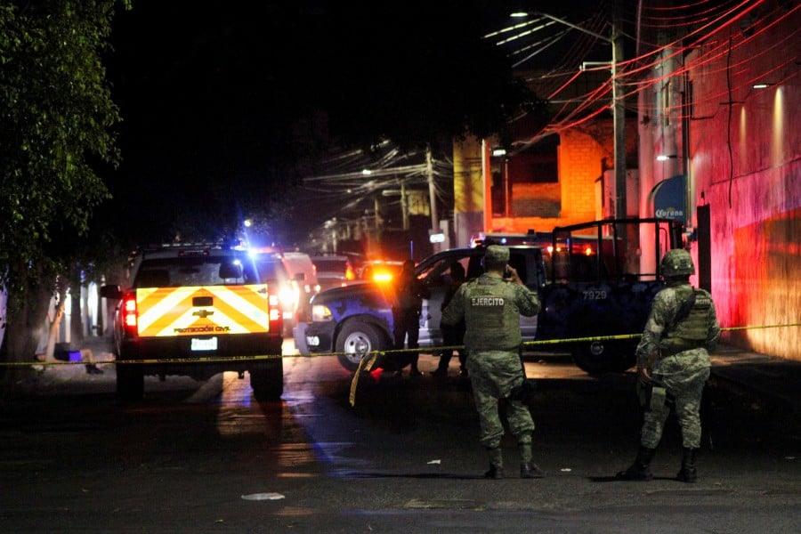 Soldiers guard the scene where gunmen opened fire in two bars killing at least 10 people, in Celaya, Mexico May 23, 2022. Picture taken May 23, 2022. - REUTERS PIC