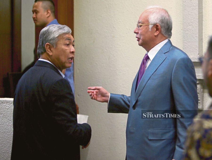 A file pic dated Nov 21, 2019, shows Datuk Seri Najib Razak (right) supporting his former deputy Datuk Seri Dr Ahmad Zahid Hamidi ahead of the Yayasan Akalbudi trial at the Kuala Lumpur Courts Complex. - NSTP file pic
