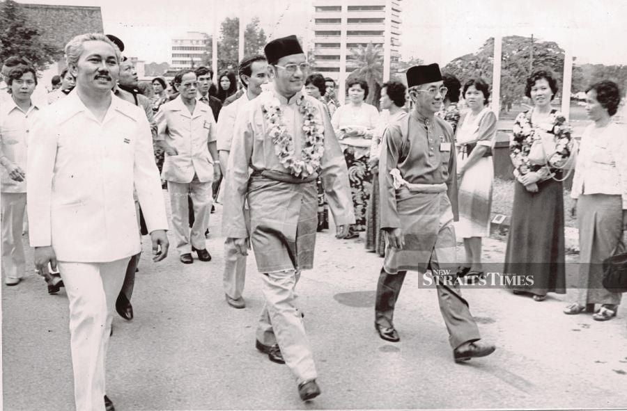 Then deputy prime minister Dr Mahathir Mohamad, who is on a one-day visit to Kuching, on his way to the Dewan Pembangunan Tun Abdul Razak for the opening of Parti Pesaka Bumiputra Bersatu’s (PBB) general assembly in March 1977. He is accompanied by PBB acting president Datuk Amar Abdul Taib Mahmud (left) and Sarawak Chief Minister Datuk Patinggi Abdul Rahman Ya’kub (right). FILE PIC 