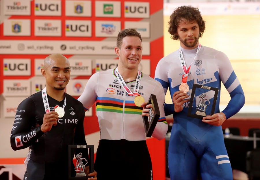 Winner Harrie Lavreysen (C) of the Netherlands, second placed Mohd Azizulhasni Awang (L) of Malaysia and third placed Mikhail Yakovlev of Israel celebrate on the podium for the Men's Keirin final at the UCI Track Cycling Nations Cup in Jakarta, Indonesia, 25 February 2023. -EPA PIC