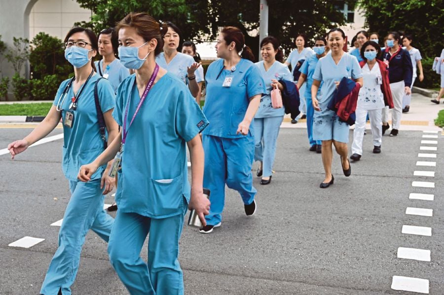 About 29,000 nurses will be eligible for the payout, including foreign nurses who have worked in the country for four years. - AFP PIC