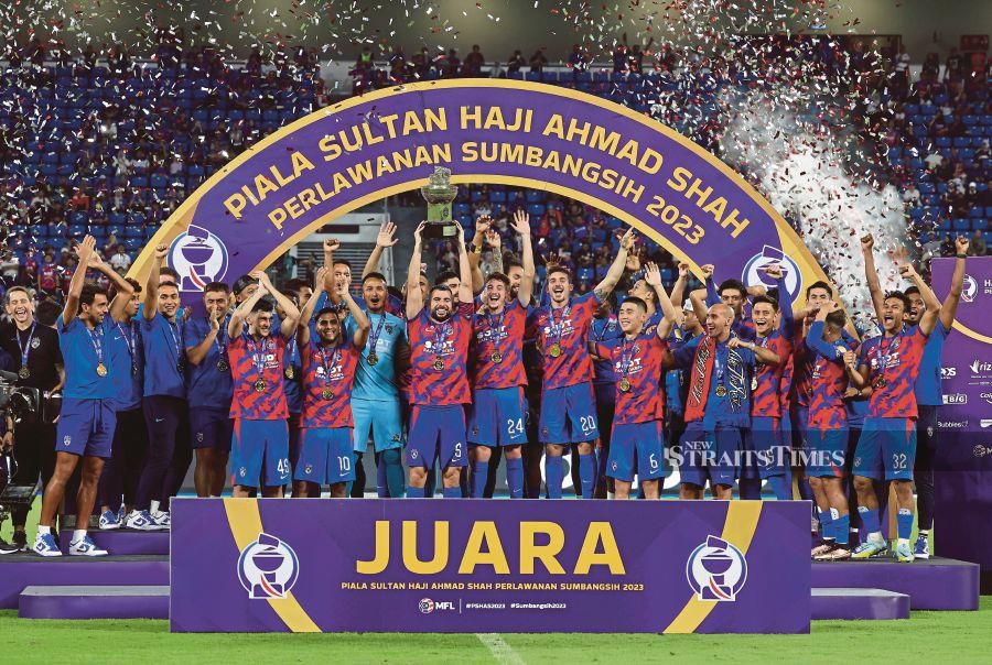 JDT celebrate winning the Charity Cup after beating Terengganu 2-0 at Sultan Ibrahim Stadium yesterday. BERNAMA pic 