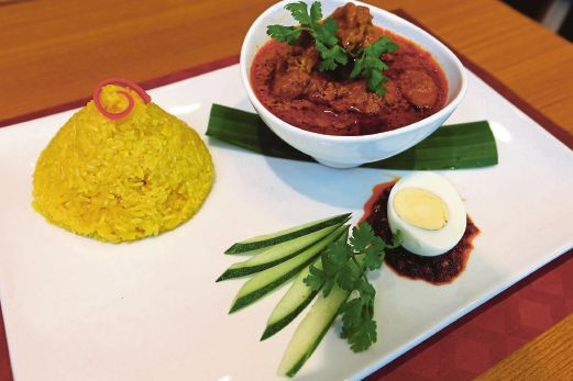 Nasi kunyit with curry chicken. Pix by Muhammad Mikail Ong
