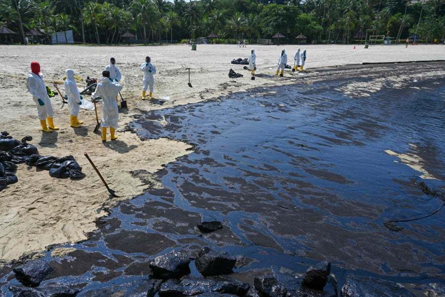 Clean-up works on the beaches in Johor and the surrounding waters began on Friday. AFP FILE PIC 