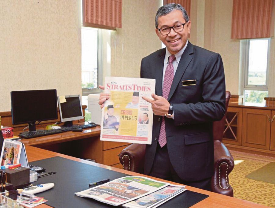 Perlis Menteri Besar, Datuk Seri Azlan Man with a copy of the New Straits Times featuring news of his appointment. Pix by Hafizudin Mohd Safar