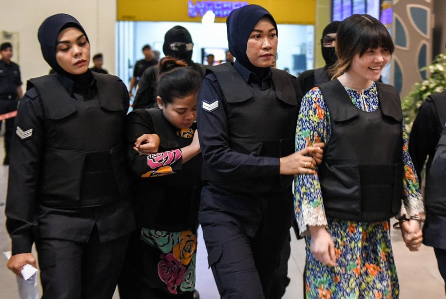  Vietnamese defendant Doan Thi Huong (R) and Indonesian defendant Siti Aishah (2nd, L) are escorted by police personnel at the low-cost carrier Kuala Lumpur International Airport 2 (KLIA2) in Sepang during a visit to the scene of the murder as part of the Shah Alam High Court trial process on October 24, 2017, for their alleged role in the assassination of Kim Jong-Nam. Indonesian Siti Aisyah, 25, and Huong, 28, have been charged with the murder of Kim Jong-Nam, the estranged half-brother of North Korean leader Kim Jong-Un, at Kuala Lumpur International Airport 2 (KLIA2) in February. AFP Photo 