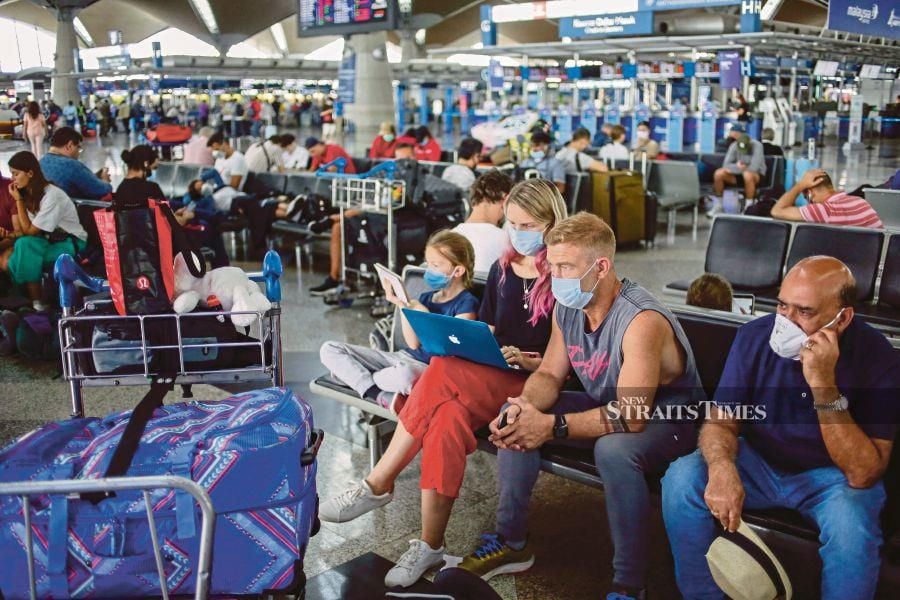 Tourists stranded at the Kuala Lumpur International Airport due to flight cancellations brought on by the Movement Control Order in March. -NSTP/ AIZUDDIN SAAD 