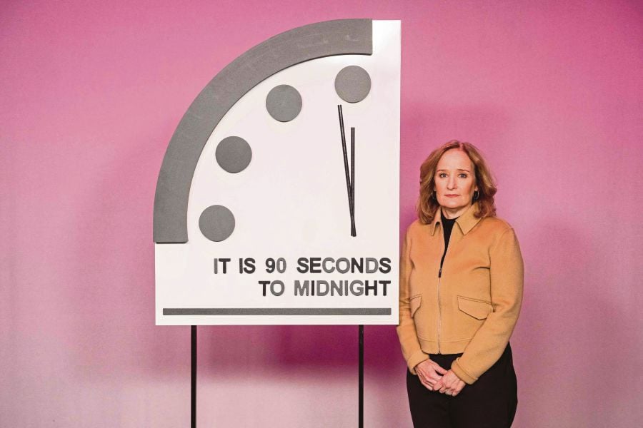 Rachel Bronson, president and CEO of the Bulletin of Atomic Scientists, standing next to the Doomsday Clock, which reads ‘It is 90 seconds to midnight’, in Washington, DC, recently. - AFP PIC 
