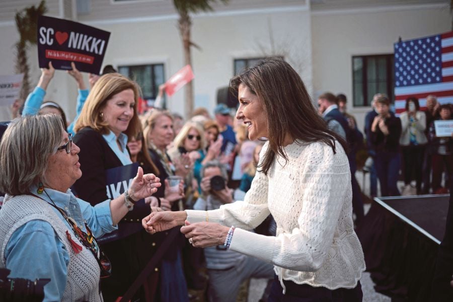  Nikki Haley (right) greeting supporters after speaking at a campaign event in Georgetown, South Carolina, on Thursday. AFP PIC 
