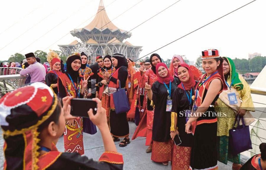 People wearing traditional attire at the Unity Week celebration in Kuching recently. The Sarawak government should look into bringing down home prices to increase people’s disposable income. - BERNAMA PIC 