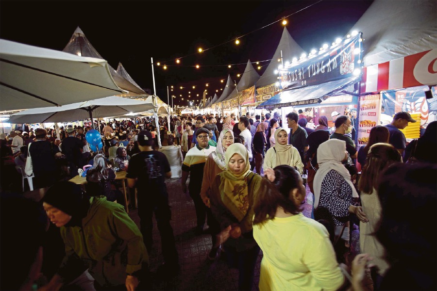 Visitors thronging the booths at night.