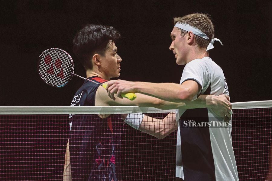 Malaysia’s Lee Zii Jia (left) and Denmark’s Viktor Axelsen during the Malaysia Masters final in Bukit Jalil in May. BERNAMA PIC 