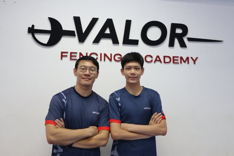  Teh Zi Hao (right) with his coach, Yu Peng Kean, at Valor Fencing Academy.