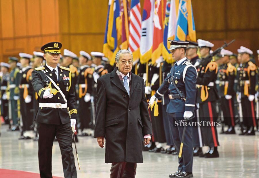 Prime Minister Tun Dr Mahathir Mohamad inspecting a guard of honour in Seoul yesterday. - Bernama