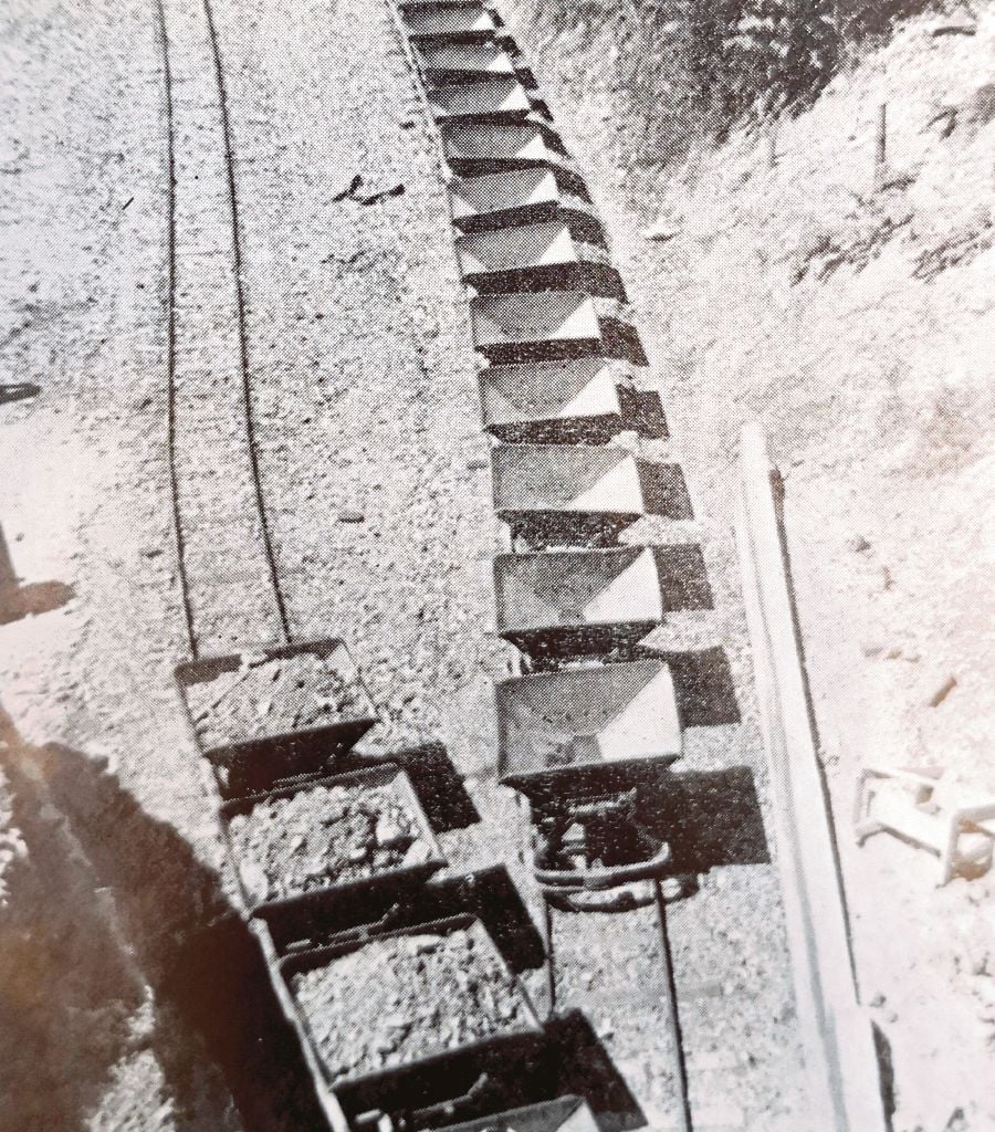 Linked trucks were used to transport the ore by rail to the mill. 
