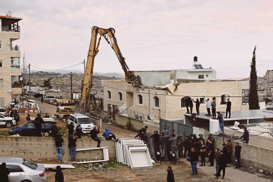 Israeli machinery demolishing a Palestinian house in Al-Tur, East Jerusalem, on Tuesday. -AFP PIC