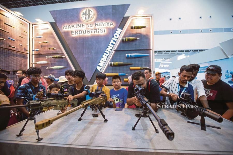 Visitors looking at the weapons on display at the Turkish Aerospace Industries’ booth at the Langkawi Maritime and Aerospace exhibition 2023 yesterday. PIC BY ASWADI ALIAS