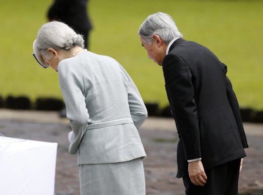  Japan's Emperor Akihito (C) with Empress Michiko (L) bow on a marker where in thousands of fallen WWII Japanese soldiers were buried during a ceremony on a mountain top in the town of Lumban, Laguna province, southeast of Manila, Philippines, 29 January 2016. Japan's Emperor and Empress are in the Philippines on a four-day visit that coincides with the 60th anniversary of the normalization of diplomatic relations between Japan and the Philippines after World War II. EPA 