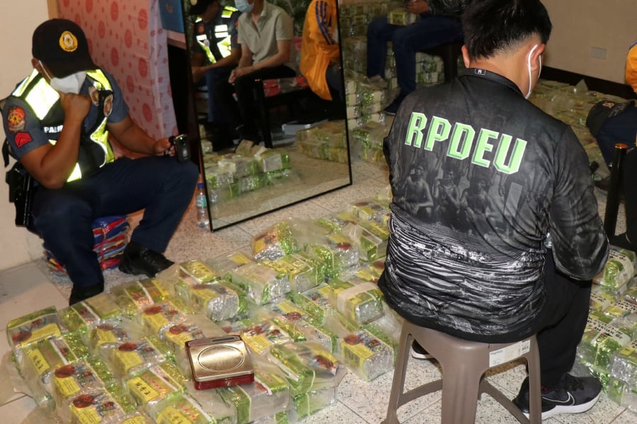 Policemen inspect tea bags containing suspected methamphetamine during a raid at a house in Baguio city, northern Philippines on Wednesday March 29, 2023. -AP PIC