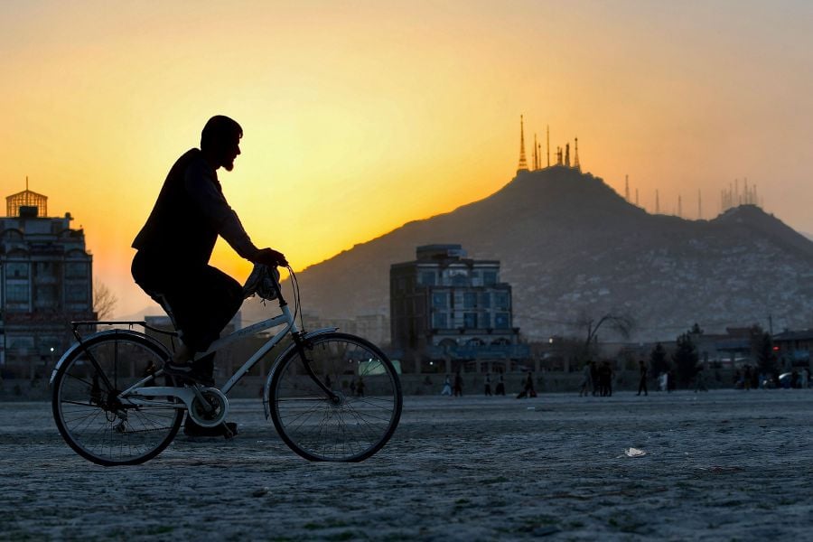 A man rides his bicycle in Chaman-e-Hozori area in Kabul. AFP FILE PIC